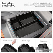 Black non-slip silicone center console organizer tray for vehicle interior protection.