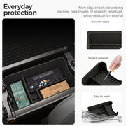 Black non-slip silicone center console organizer tray for vehicle protection and storage.