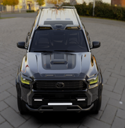 Custom black 4x4 off-road vehicle with roof rack and LED light bars on a paved street.