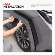 Installing black matte fender flares on a grey 4x4 vehicle wheel arch.