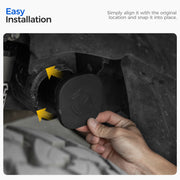 Hand installing a black protective rubber plug into a vehicle chassis opening.