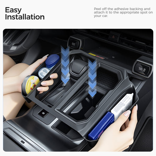 Installing a black car center console organizer tray for improved vehicle storage.