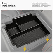 Black center console organizer tray for vehicle interior with rubberized liners.