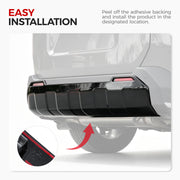Easy installation of a black rear bumper protector on a 4x4 vehicle.