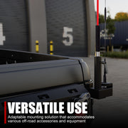Versatile black mounting bracket for off-road accessories and antenna on a truck bed.