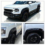 Black heavy-duty fender flares installed on a white 4x4 pickup truck for vehicle protection.