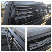 Glossy black rear window louvers installed on a 4x4 vehicle for rear window protection.