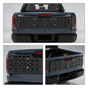 Black heavy-duty modular tailgate rack mounted on a blue 4x4 pickup truck bed.