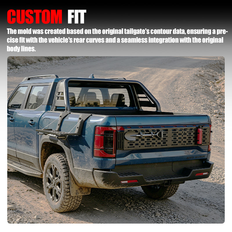 Custom fit black tailgate protector and roll bar installed on a blue 4x4 pickup truck.
