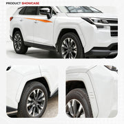 White SUV featuring protective side door decals and rugged wheel arch trim.