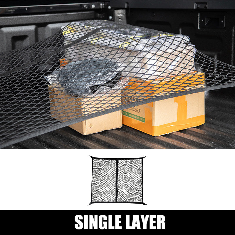 Single layer black cargo net securing boxes in a 4x4 truck bed.