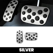 Silver stainless steel car pedal covers with black anti-slip rubber studs.